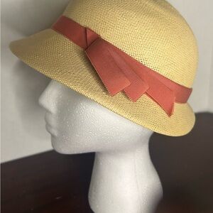 This is a vintage Betmar straw hat with an orange ribbon.